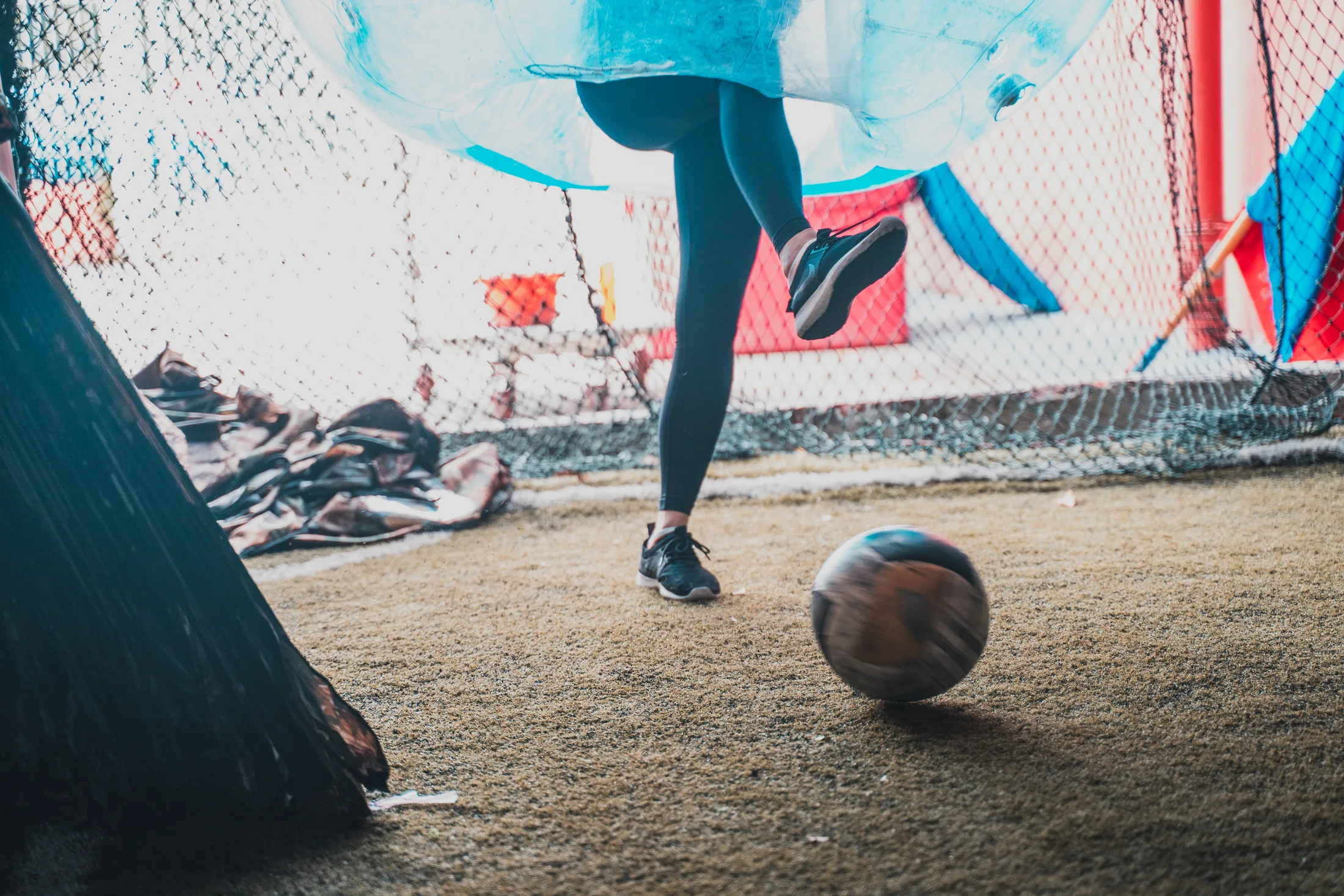 Football rolling on turf during a Bubble Soccer game