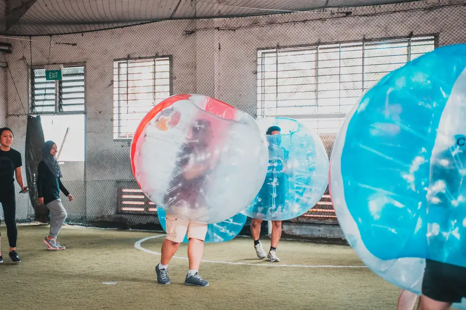 Hosted Bubble Soccer round with players in inflatable suits on an indoor turf pitch