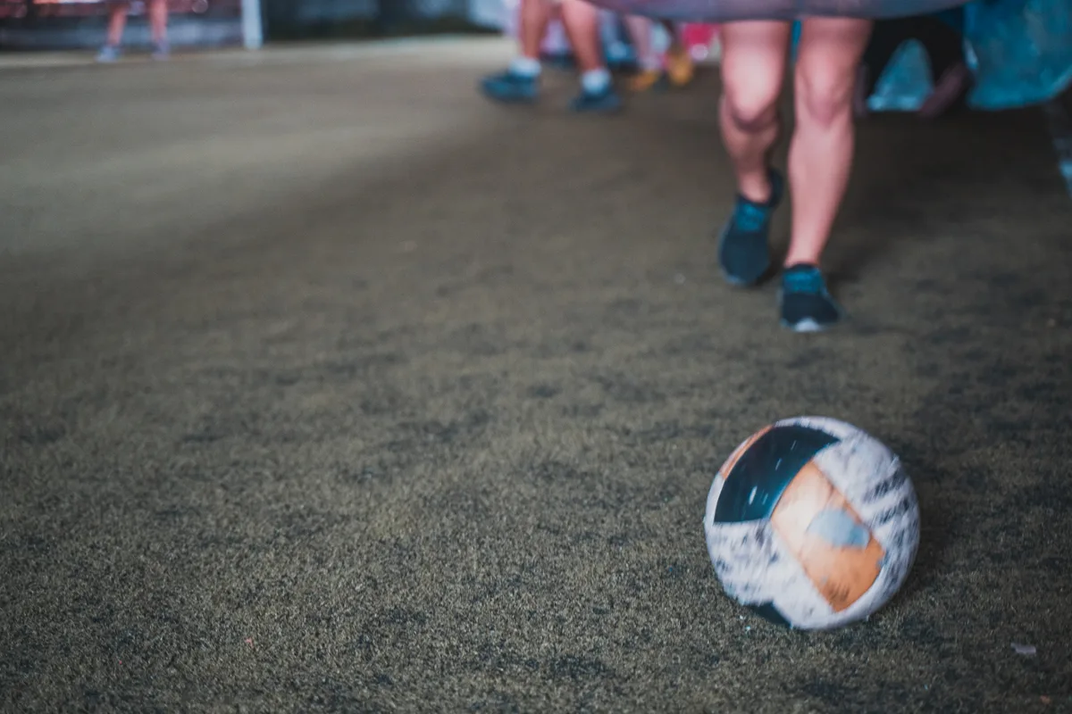 Bubble Soccer ball on turf with players preparing to move into the next round