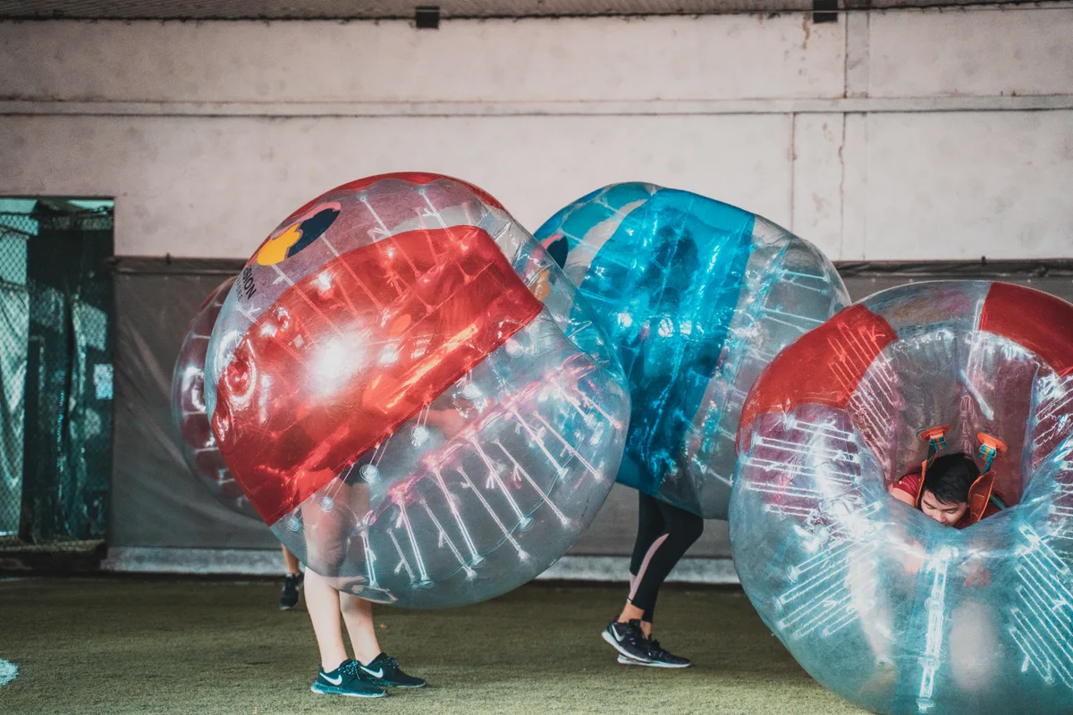 Bubble Soccer player stepping toward the ball during a competitive indoor round
