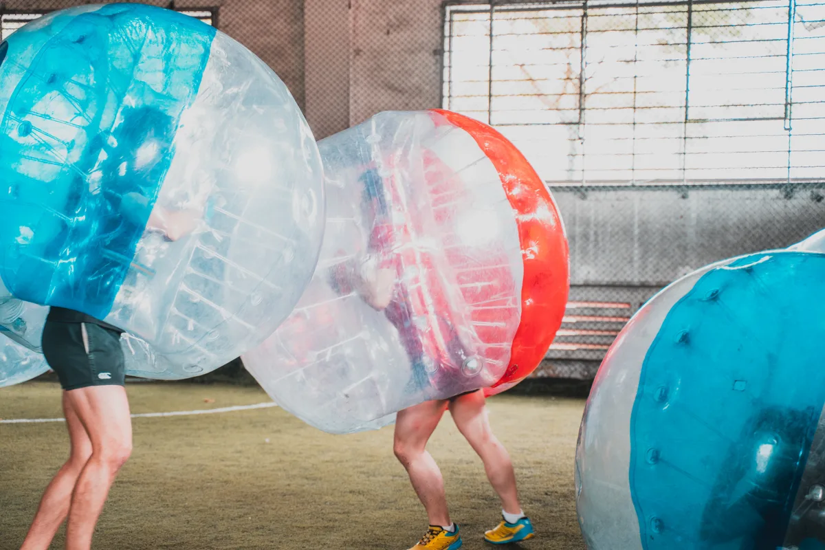 Bubble Soccer players colliding during a controlled indoor round