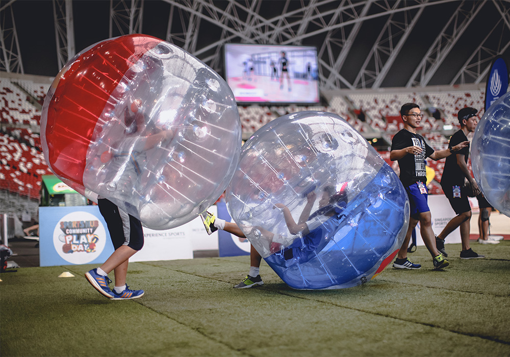 Bubble Soccer bumping game mode with players in bubble suits